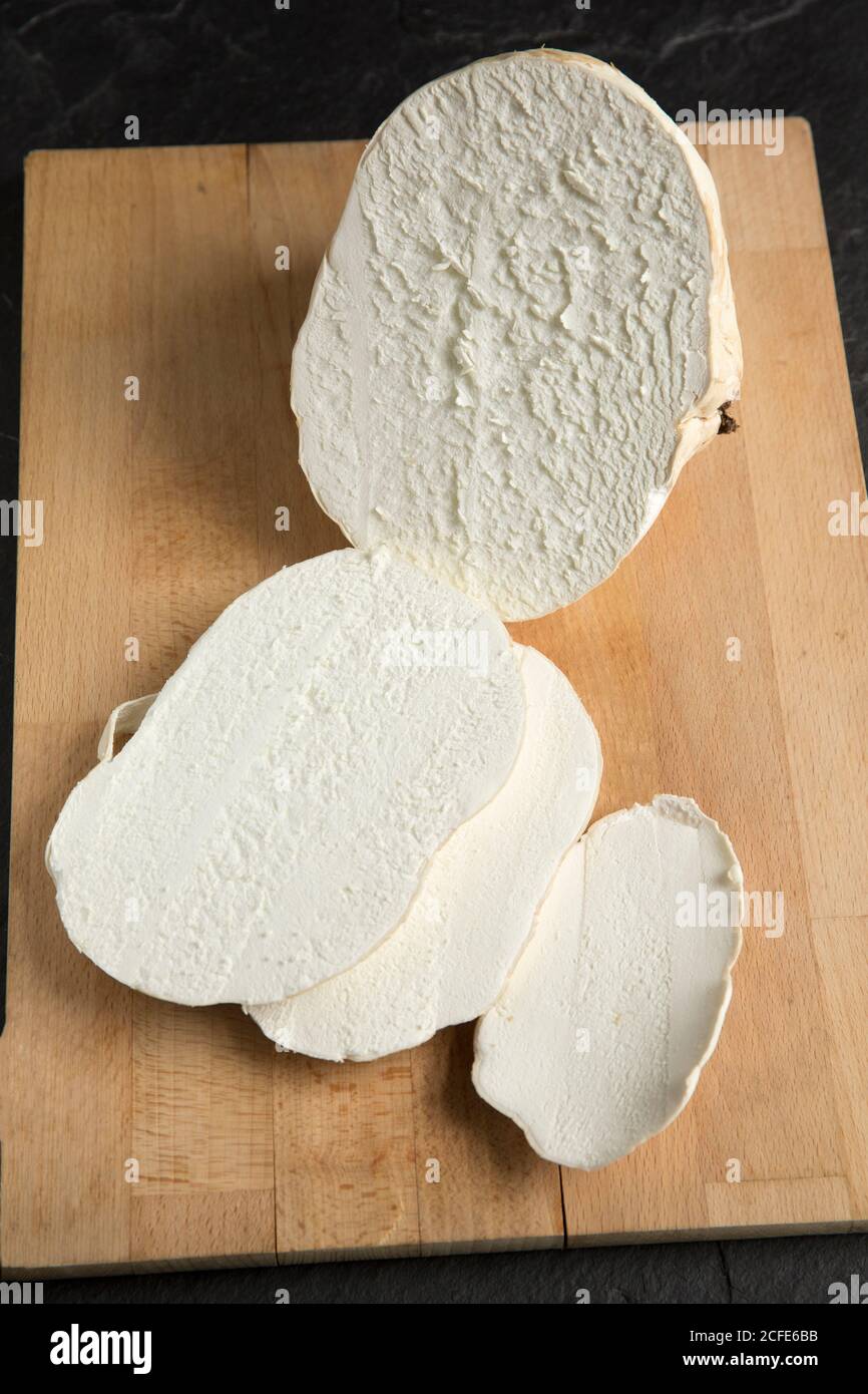 A giant puffball, Calvatia gigantea, that was picked in a pasture field and taken for cooking. The puffball is shown with several slices in preparatio Stock Photo