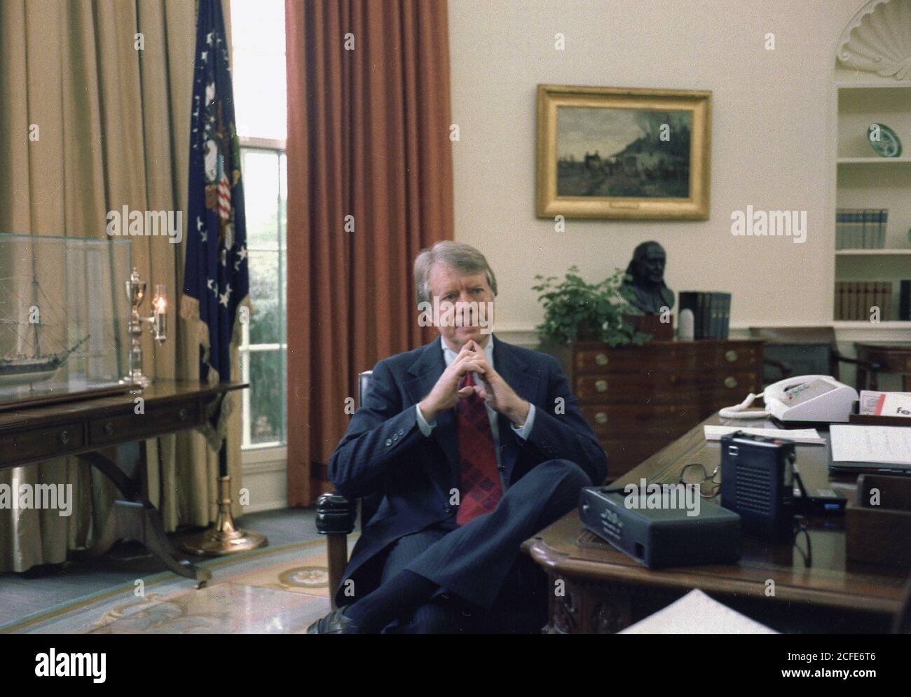 Jimmy Carter at his desk in the Oval Office ca. 13 December 1977 Stock