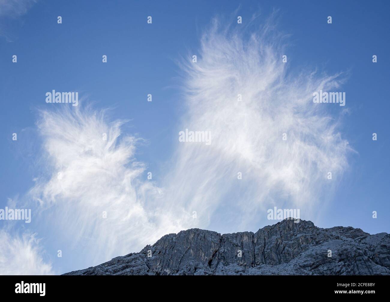 Bizarre cloud formation against a blue sky and rock massif at Alpspitze, Garmisch-Partenkirchen, Upper Bavaria, Bavaria, southern Germany, Germany Stock Photo