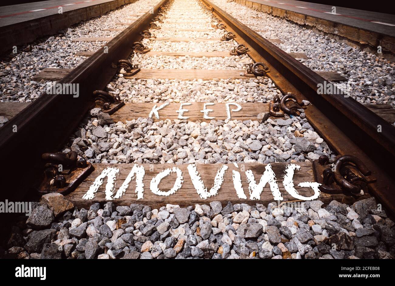 keep moving phrase handwritten on rail way Stock Photo