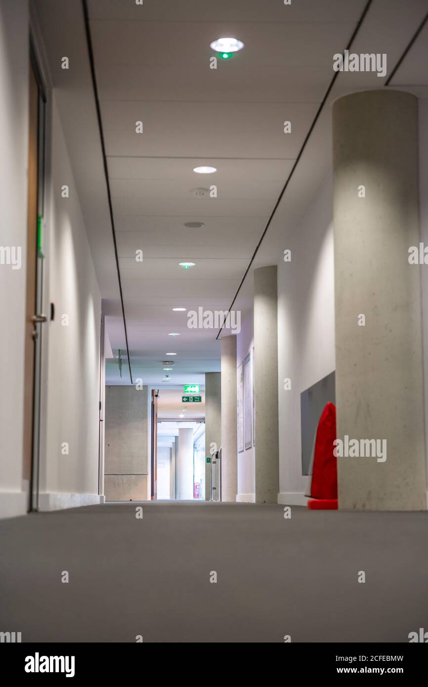 Empty long corridor in a modern office building. Stock Photo