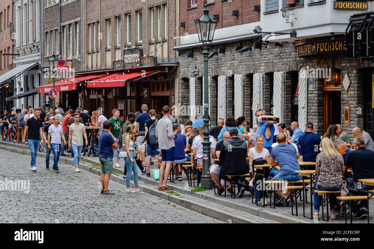 Duesseldorf, North Rhine-Westphalia, Germany - Düsseldorf's old town in times of the corona pandemic, people sit in front of pubs and restaurants at Stock Photo