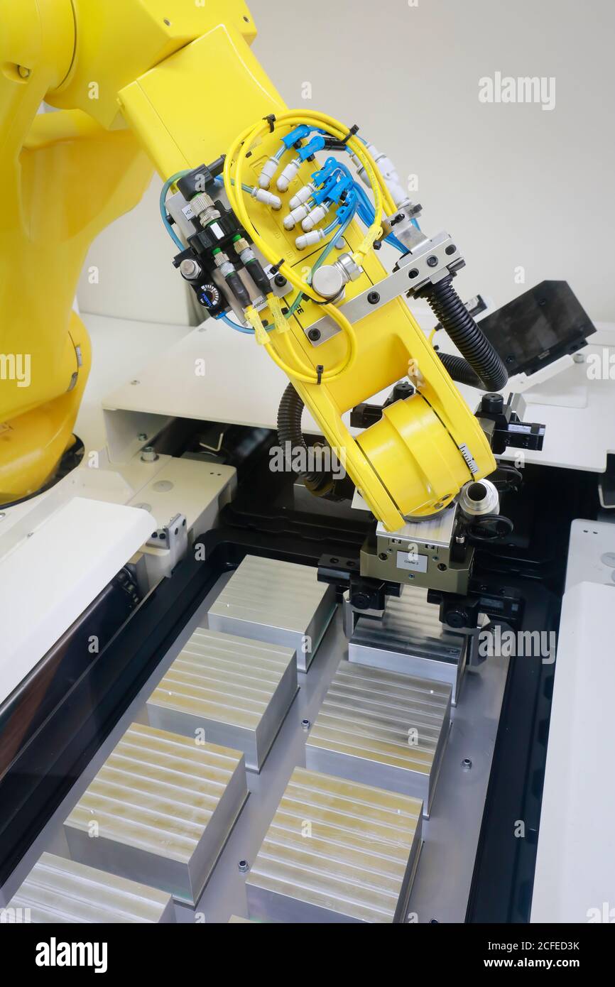 Bochum, North Rhine-Westphalia, Germany - robot arm equips a CNC milling machine with workpieces here at Stromboli Elektro und Feinwerktechnik on the Stock Photo