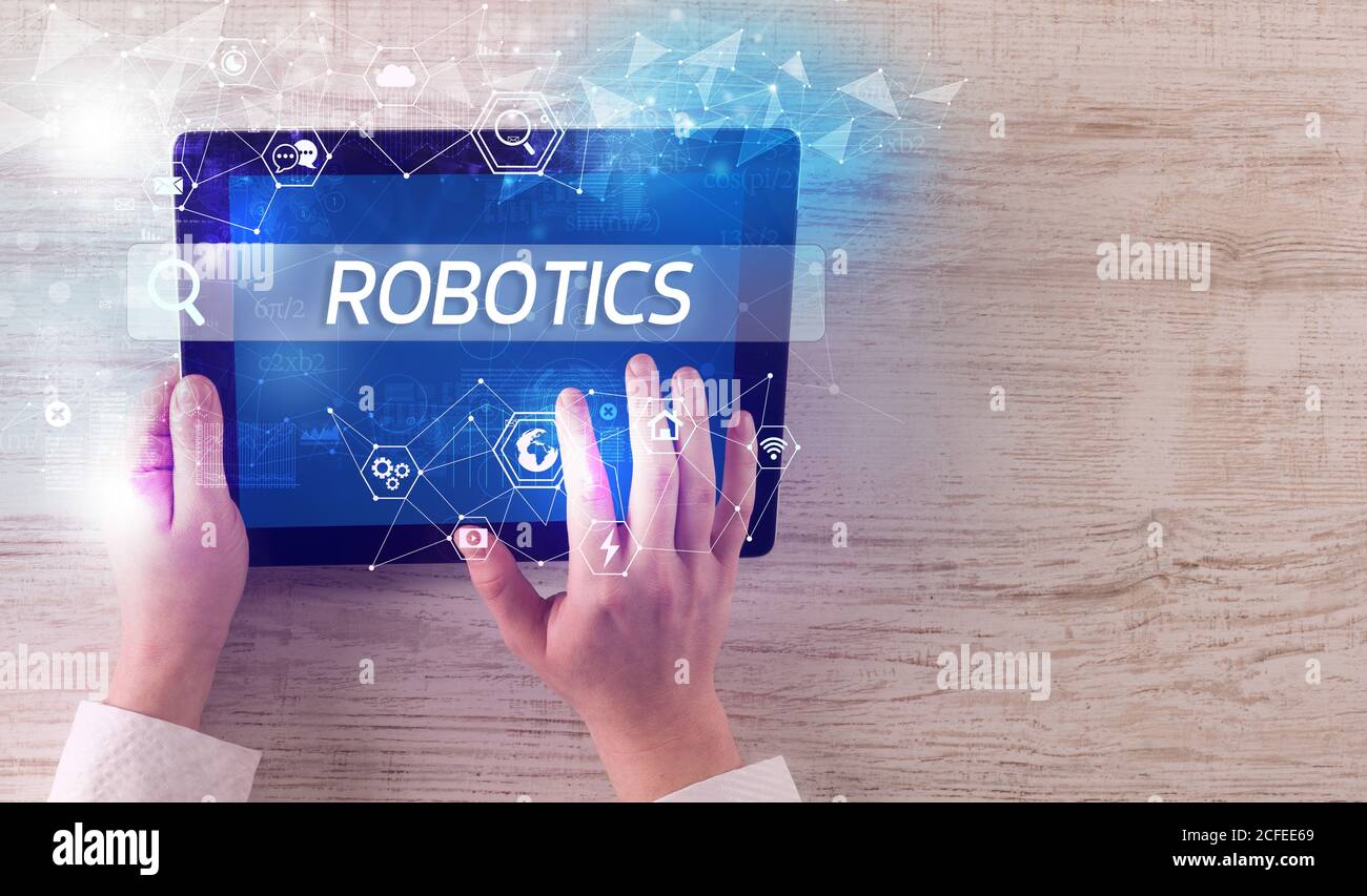 Inscription Technology Close-up of a tablet searching ROBOTICS inscription, hi-tech computing ...