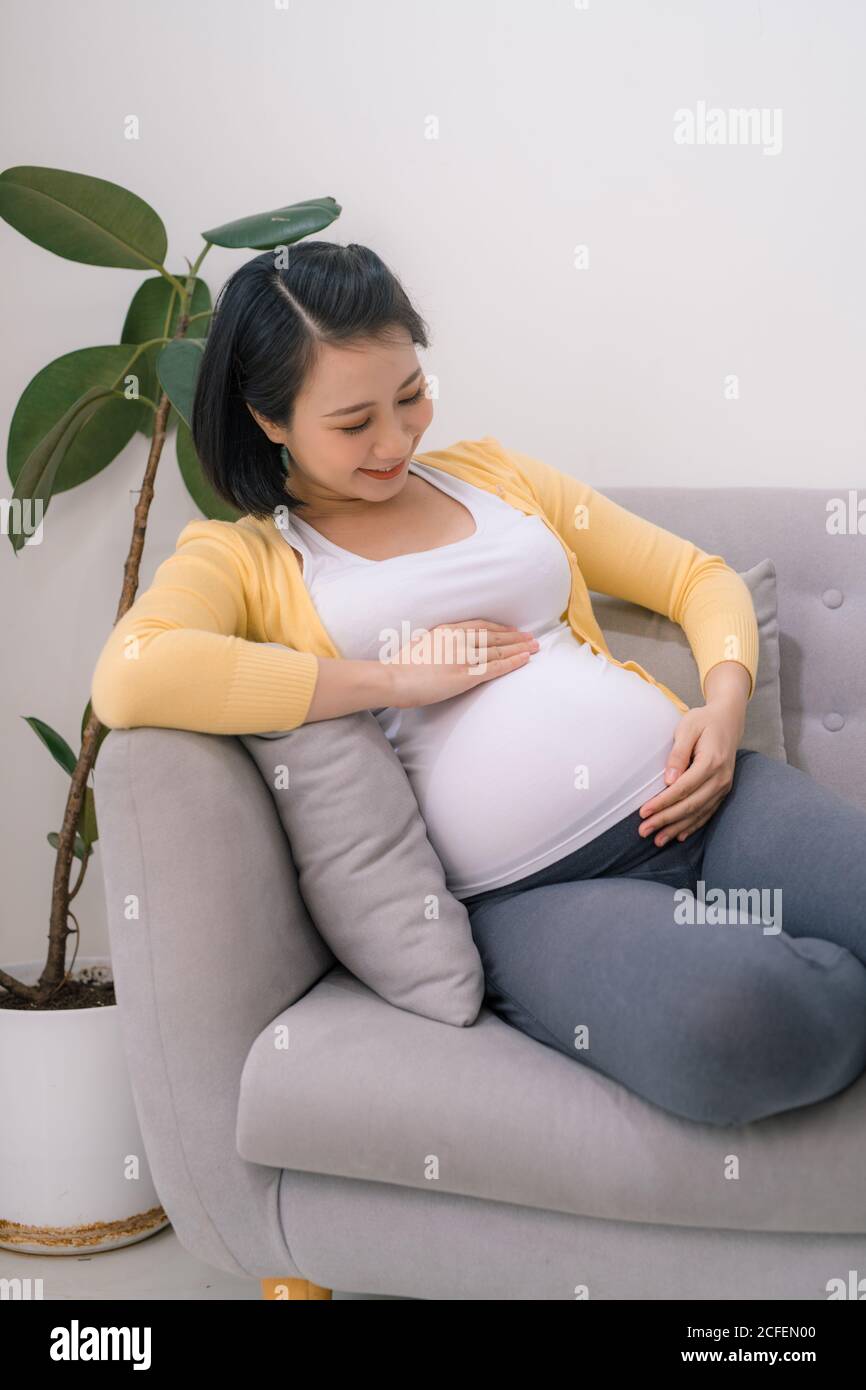 smiling pregnant asian woman Stock Photo