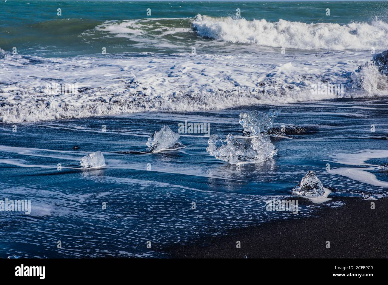 Diamond beach, big ice rocks on a black beach, at south coast of ...