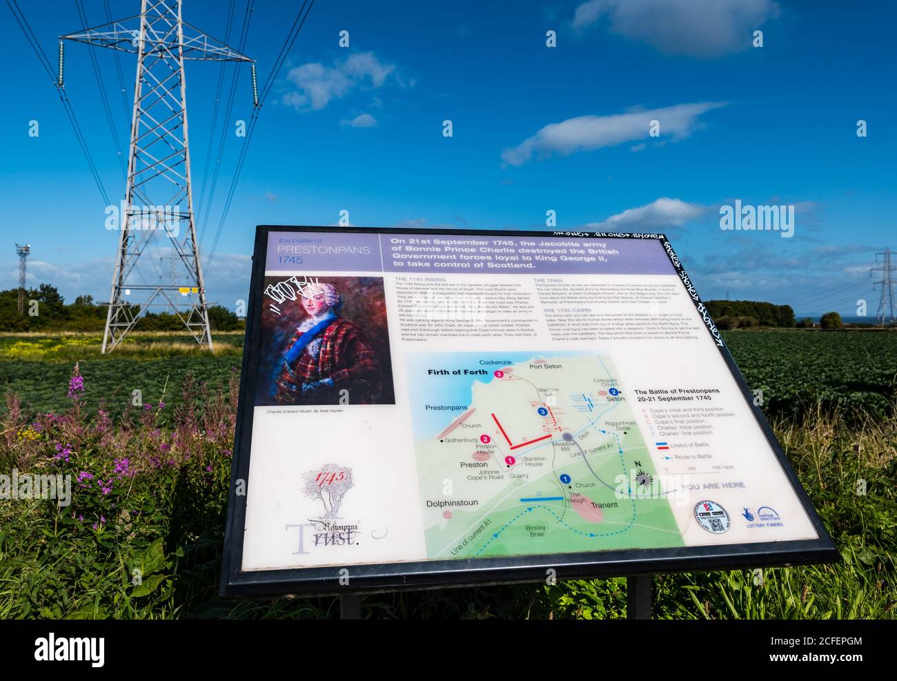 Prestonpans, East Lothian, Scotland, United Kingdom, 5th September 2020. Preparations for the 275th anniversary of the Battle of Prestonpans in which the Jacobites, led by Charles Edward Stuart, defeated the British Army led by Sir john Cope on 21st September in 1745. New interpretation boards around the battlefield have been put in place. Commemorations will be online this year.. A new interpretation board by the roadside next to an electricity pylon Stock Photo