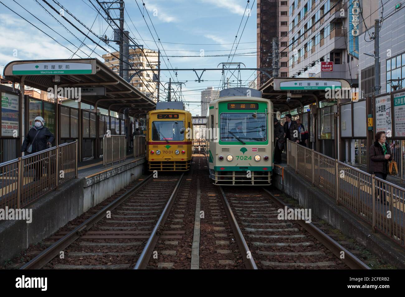 Two tram or street cars on the Toden Arakawa Line, known as the Tokyo Sakura tram at Machiya- Ekimae station in Tokyo, Japan Stock Photo