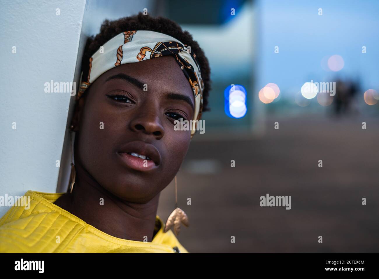 African woman sitting side view hi-res stock photography and images - Alamy