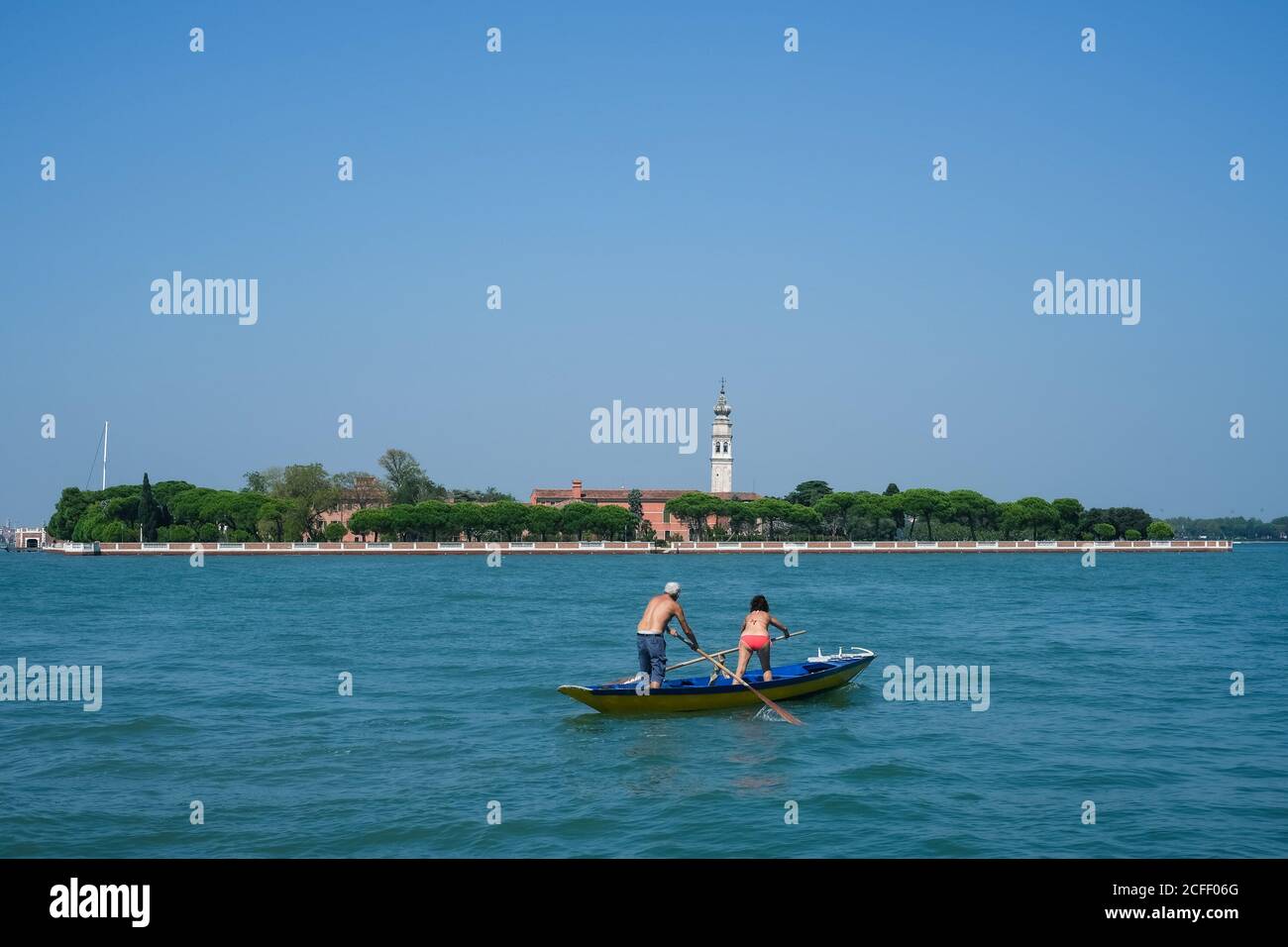 Atmosphere around Venice on Saturday 5 September 2020 at , Venice. A couple scull a boat across the lagoon. Picture by Julie Edwards. Stock Photo