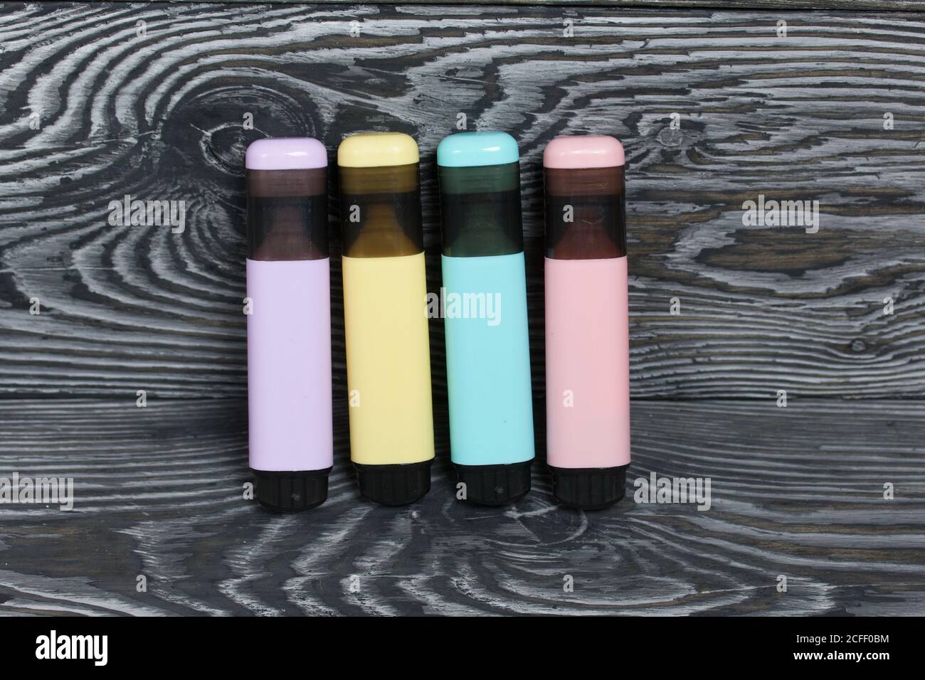 Colored markers. On brushed pine boards painted black and white. Stock Photo