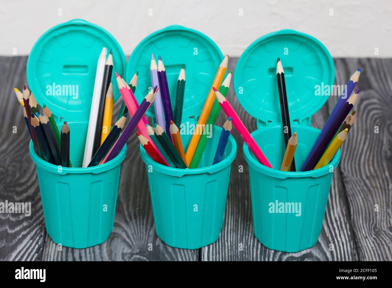 Colored pencils in pencil holders. A pencil case in the form of a trash