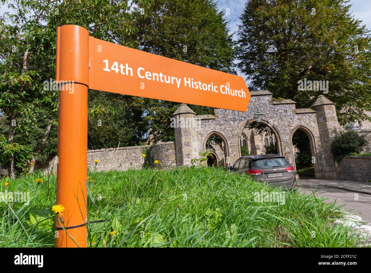 Modern fingerpost sign pointing to a 14th century historic church in Arundel, West Sussex, England, UK. Stock Photo