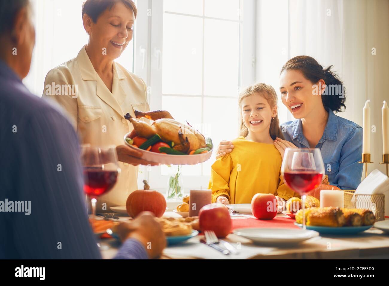 Happy Thanksgiving Day! Autumn feast. Family sitting at the table and