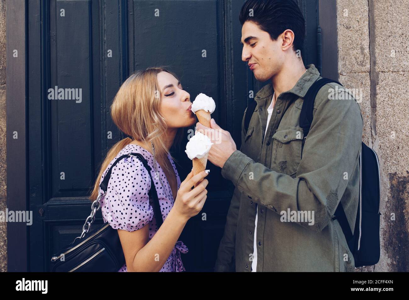 Cheerful young attractive Woman and boyfriend eating of ice