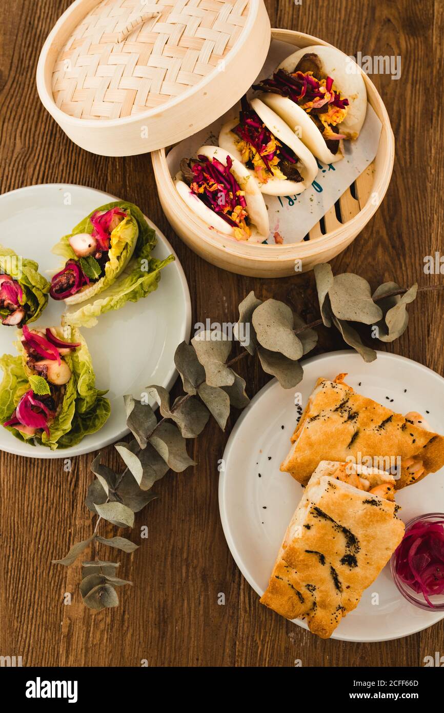 Various selection of different plates placed in wooden table Stock Photo