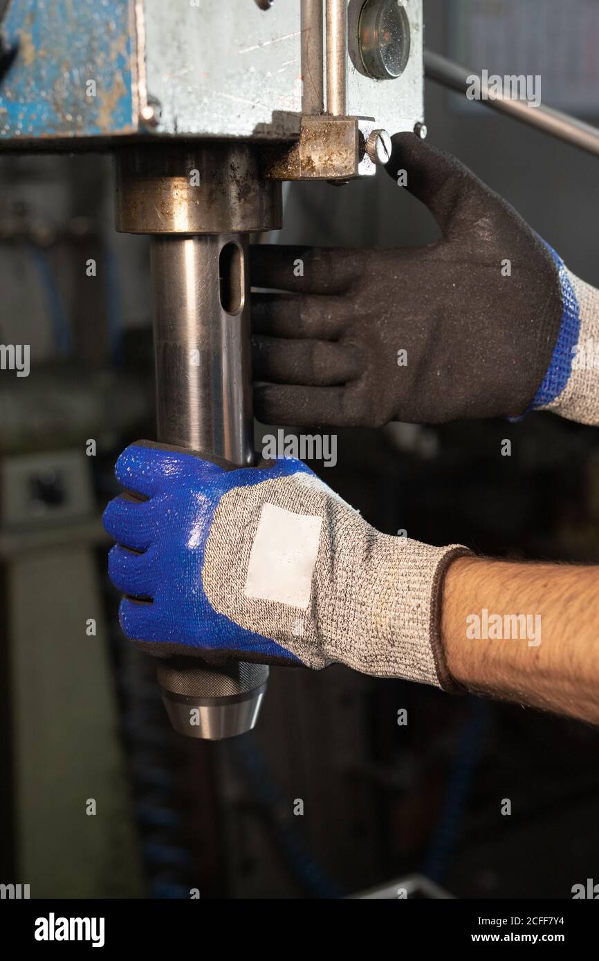 anonymous foreman working on equipment with valve on factory Stock Photo