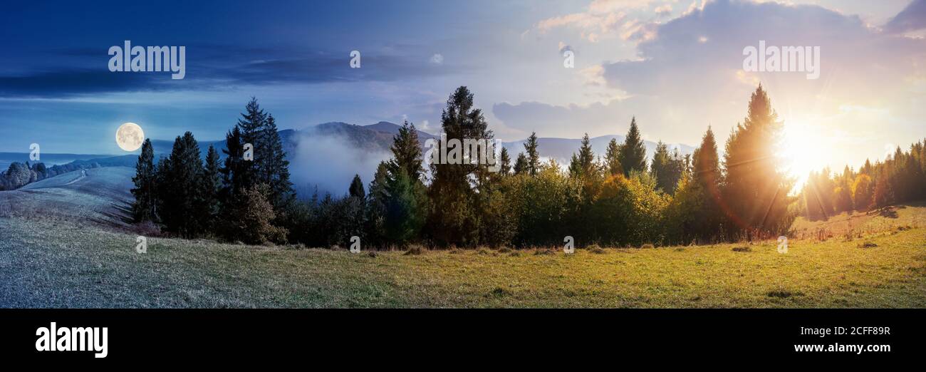 day and night time change concept of foggy autumn panorama. spruce trees on the meadow beneath a sun and moon. mountain behind the mist. cloud inversi Stock Photo
