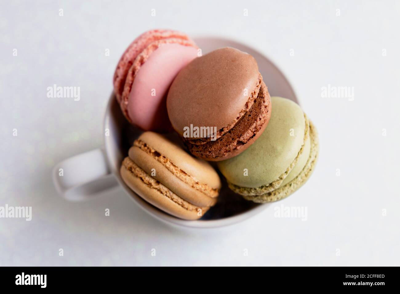 Bowl of macaroons on table Stock Photo