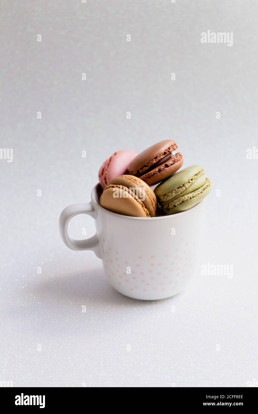 Bowl of macaroons on table Stock Photo