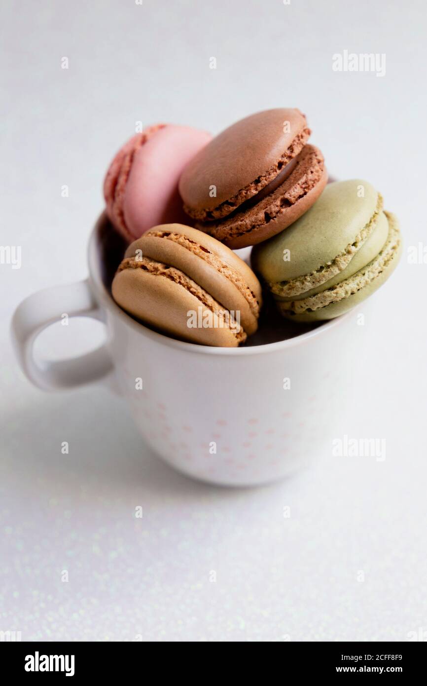 Bowl of macaroons on table Stock Photo