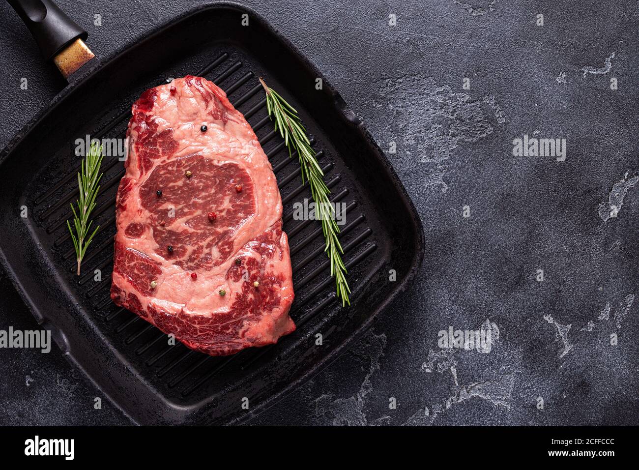 Fresh raw beef steak on frying grill pan, top view. Stock Photo
