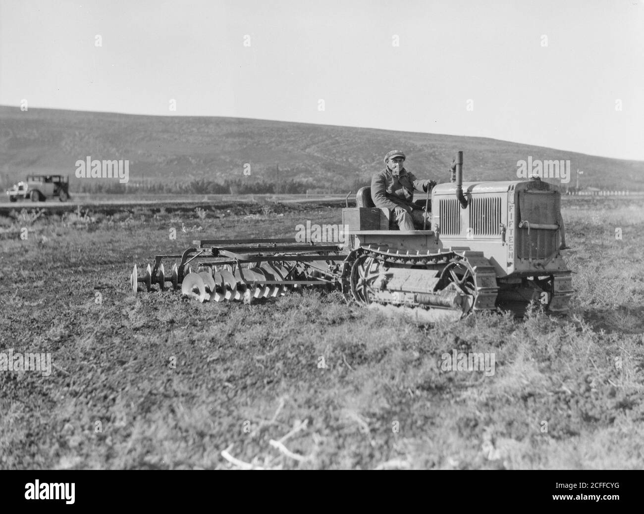'Middle East History - The Keren Hayesod. Agricultural Colonies on Plain of Esdraelon ''The Emek.'' Tractor disc plowing on the great stretches of Esdraelon' Stock Photo