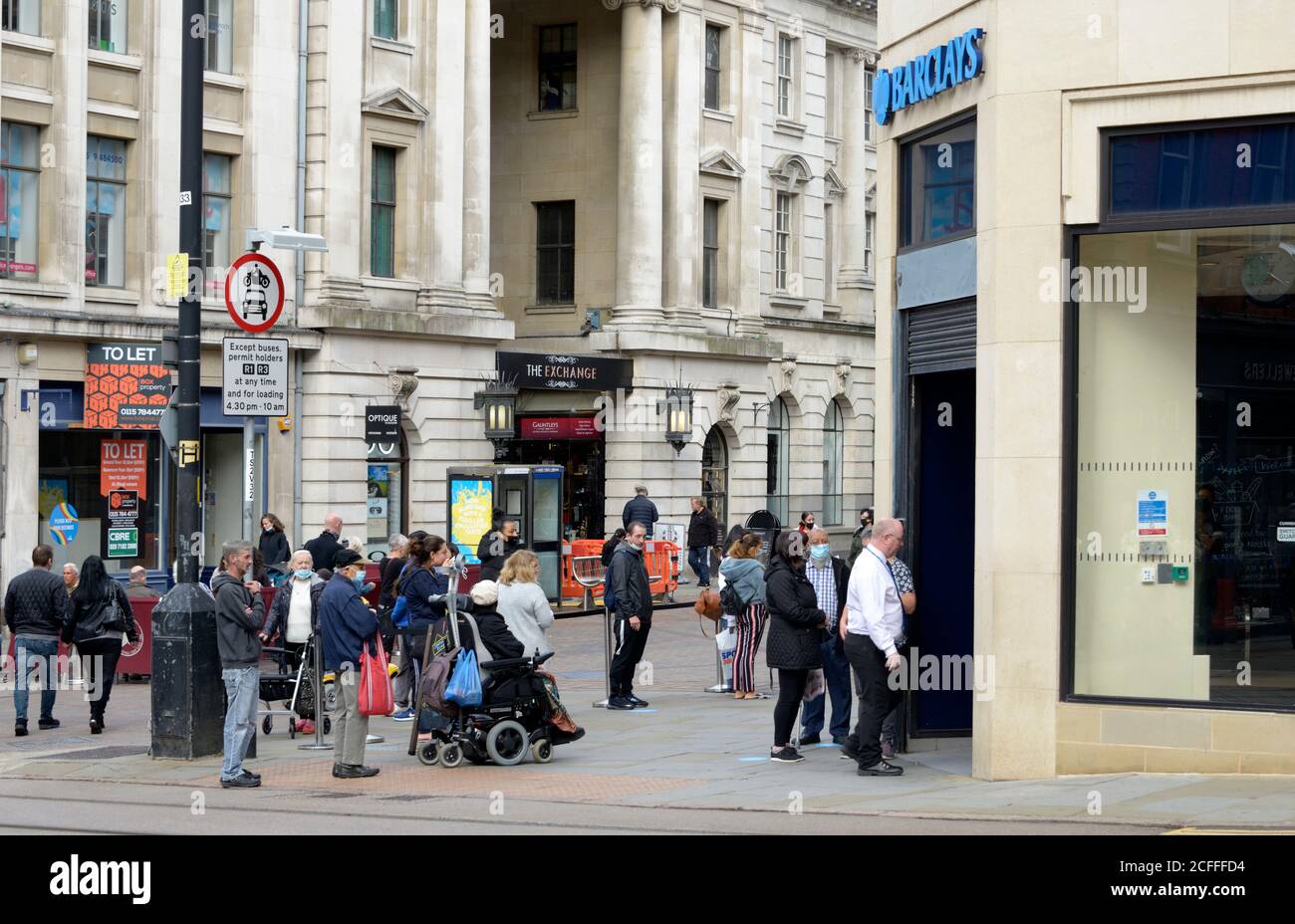 People queueing for Barclays Bank, during Virus outbreak. Stock Photo