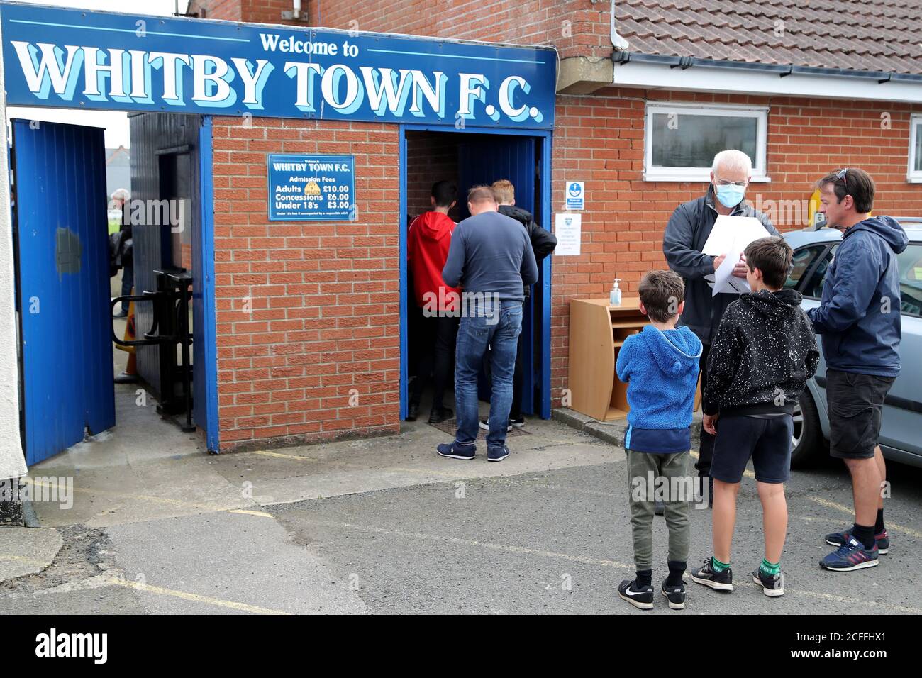Football fans queue before the preseason friendly match at the Towbar