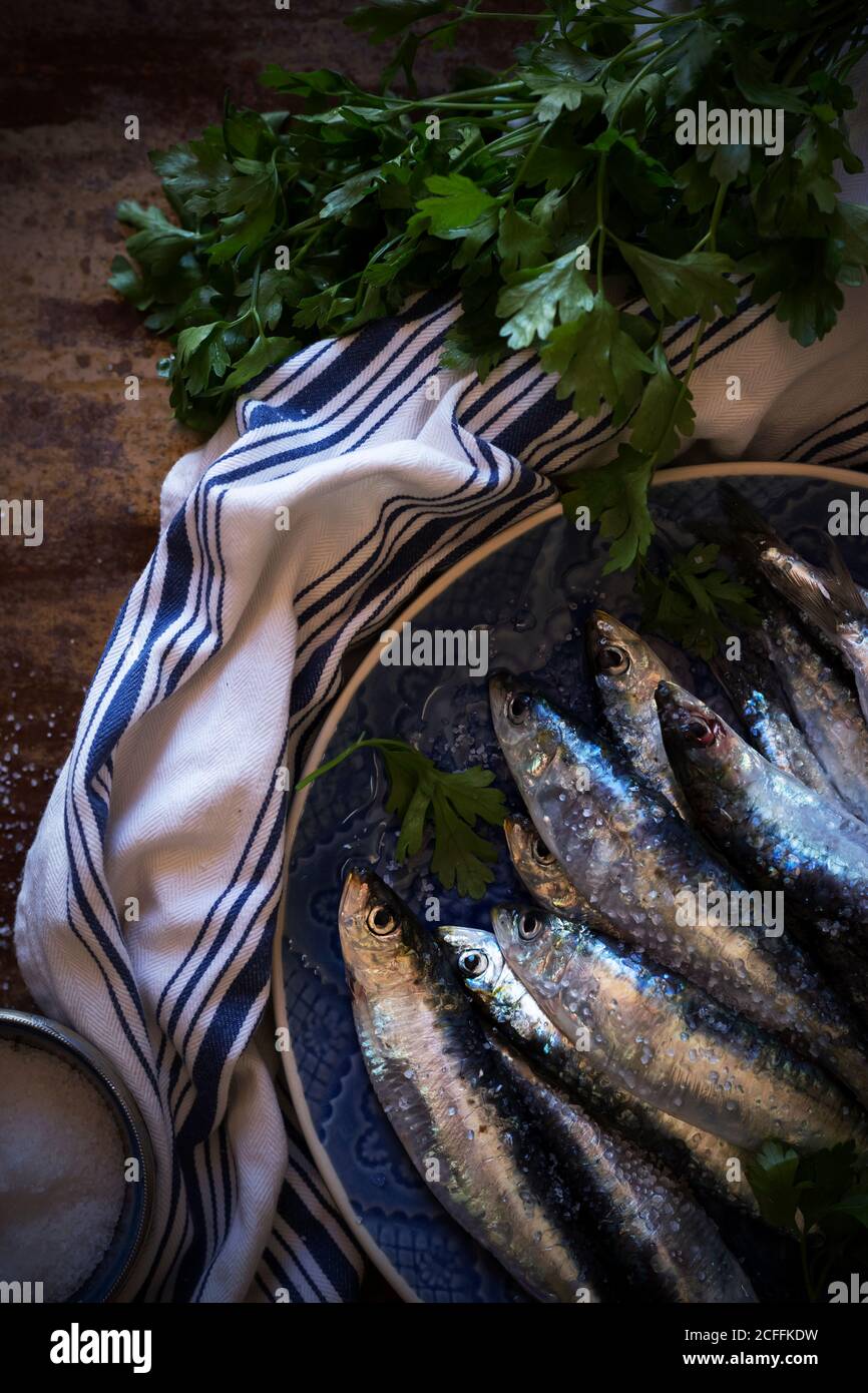 Salty anchovies with parsley Stock Photo