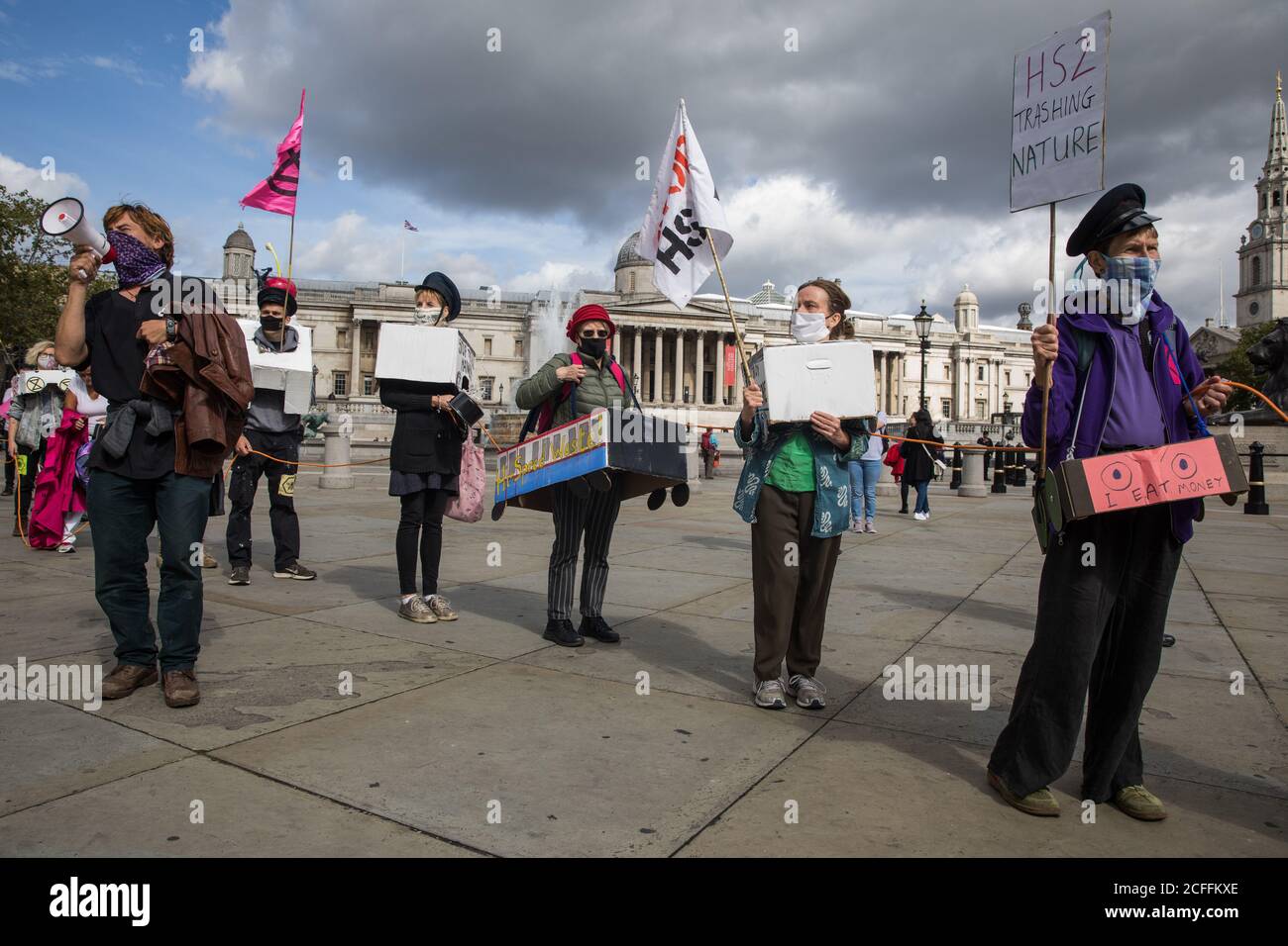 London, UK. 4th September, 2020. Activists from HS2 Rebellion, an umbrella campaign group comprising longstanding campaigners against the HS2 high-speed rail link as well as Extinction Rebellion activists, march through Trafalgar Square with the handmade Boris the Bank Engine to a protest rally in Parliament Square. The rally, and a later protest action at the Department of Transport during which activists glued themselves to the doors and pavement outside and sprayed fake blood around the entrance, coincided with an announcement by HS2 Ltd that construction of the controversial £106bn high-sp Stock Photo