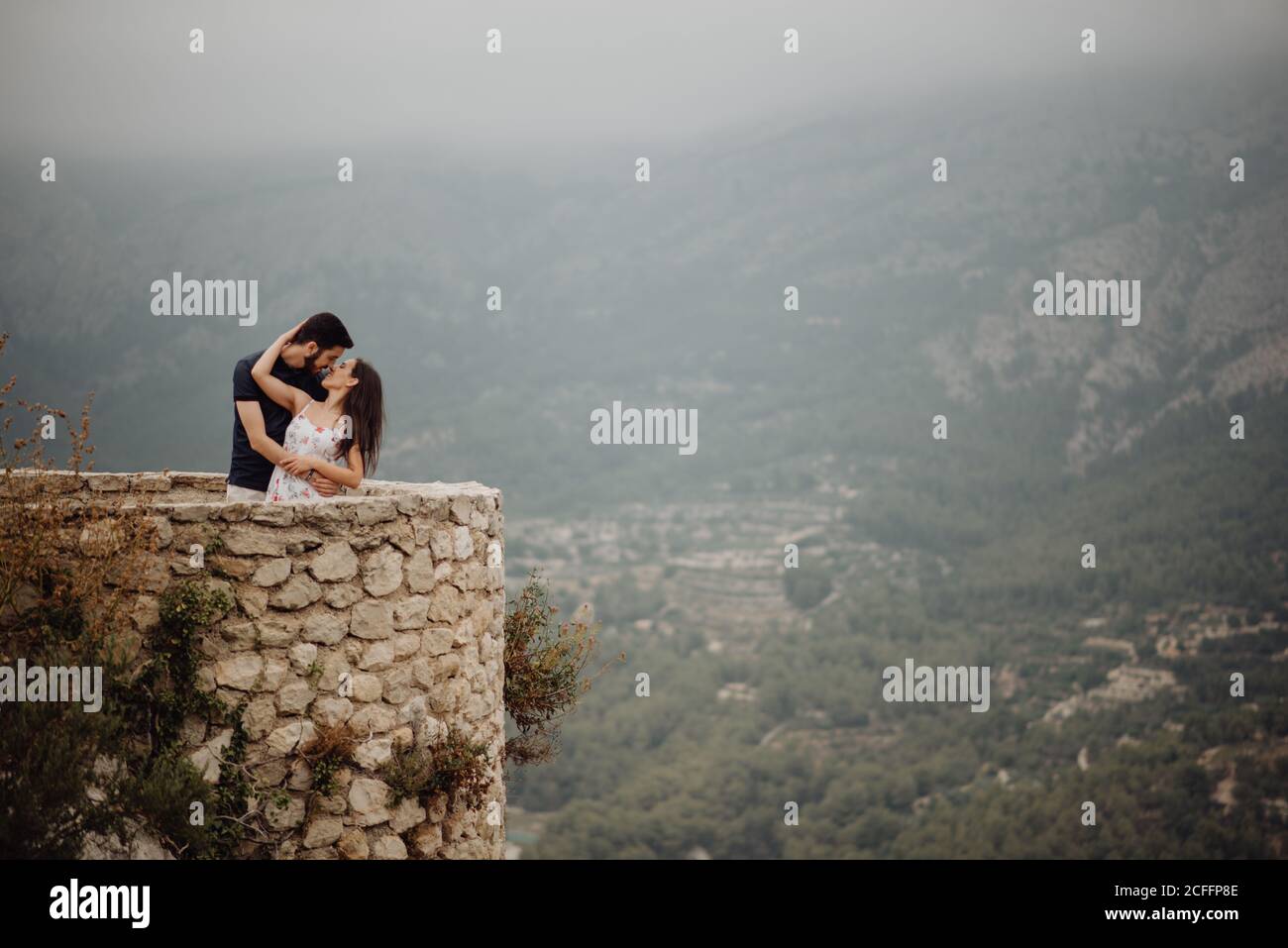 Couple kissing against tree hi-res stock photography and images - Alamy