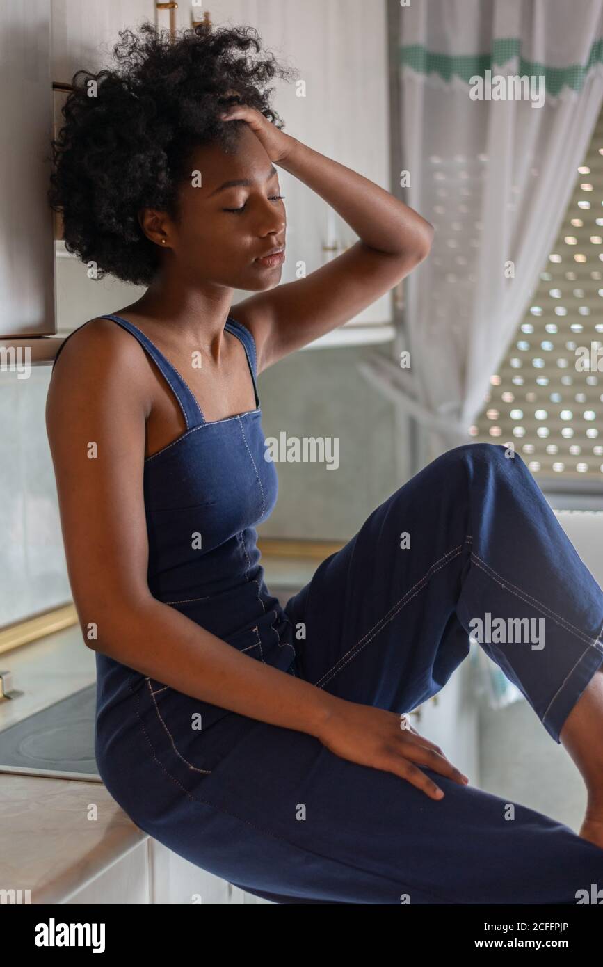 side-view-of-thoughtful-exhausted-black-housewife-with-afro-hairstyle