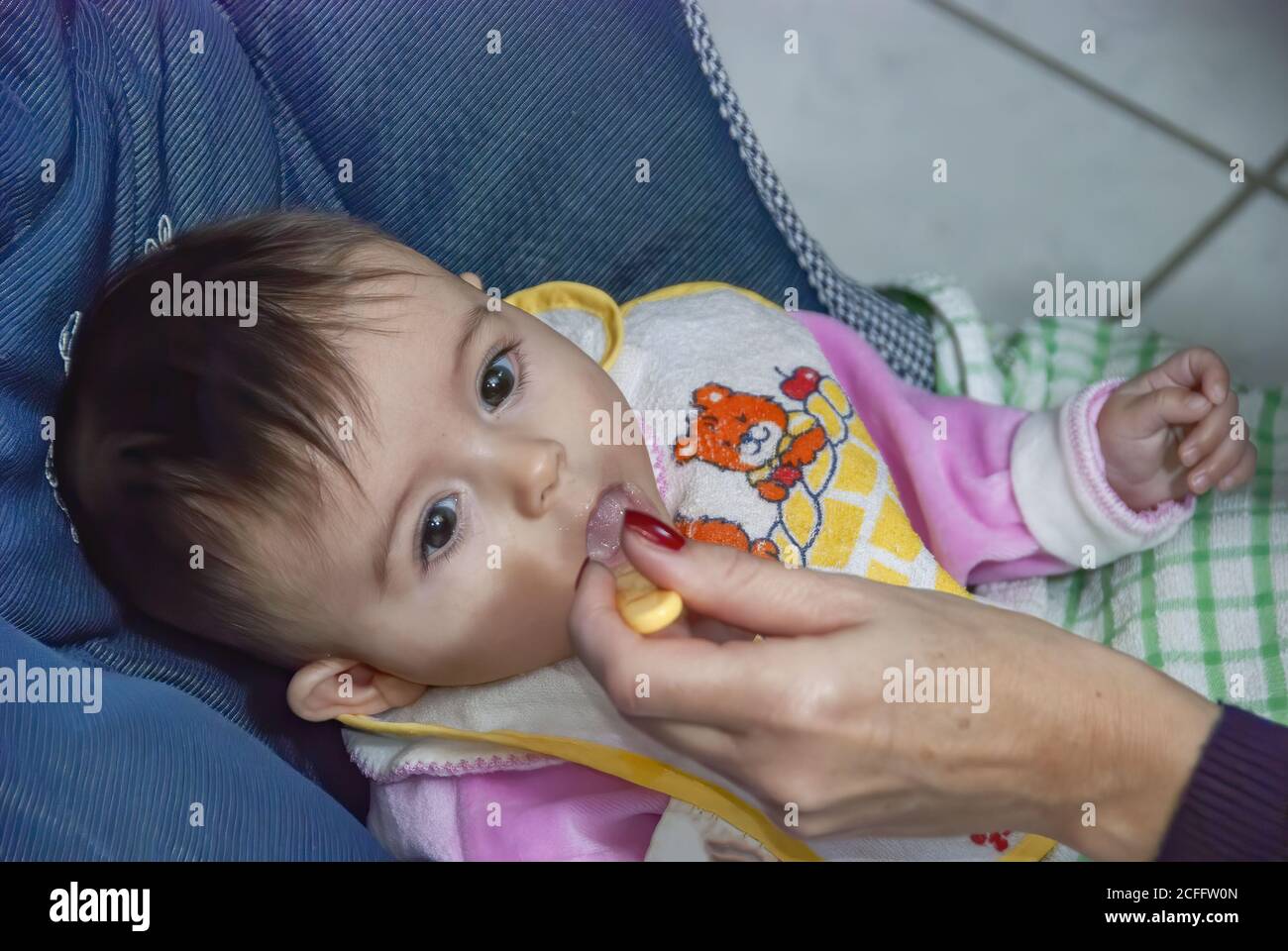 Feeding a young a child with a spoon Stock Photo - Alamy