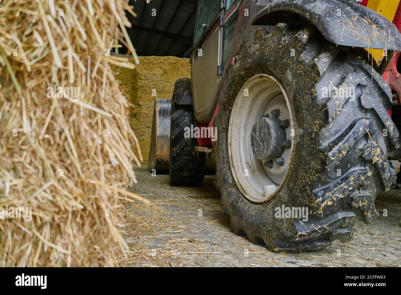 Dirty tractor wheel in garage on farm Stock Photo Alamy