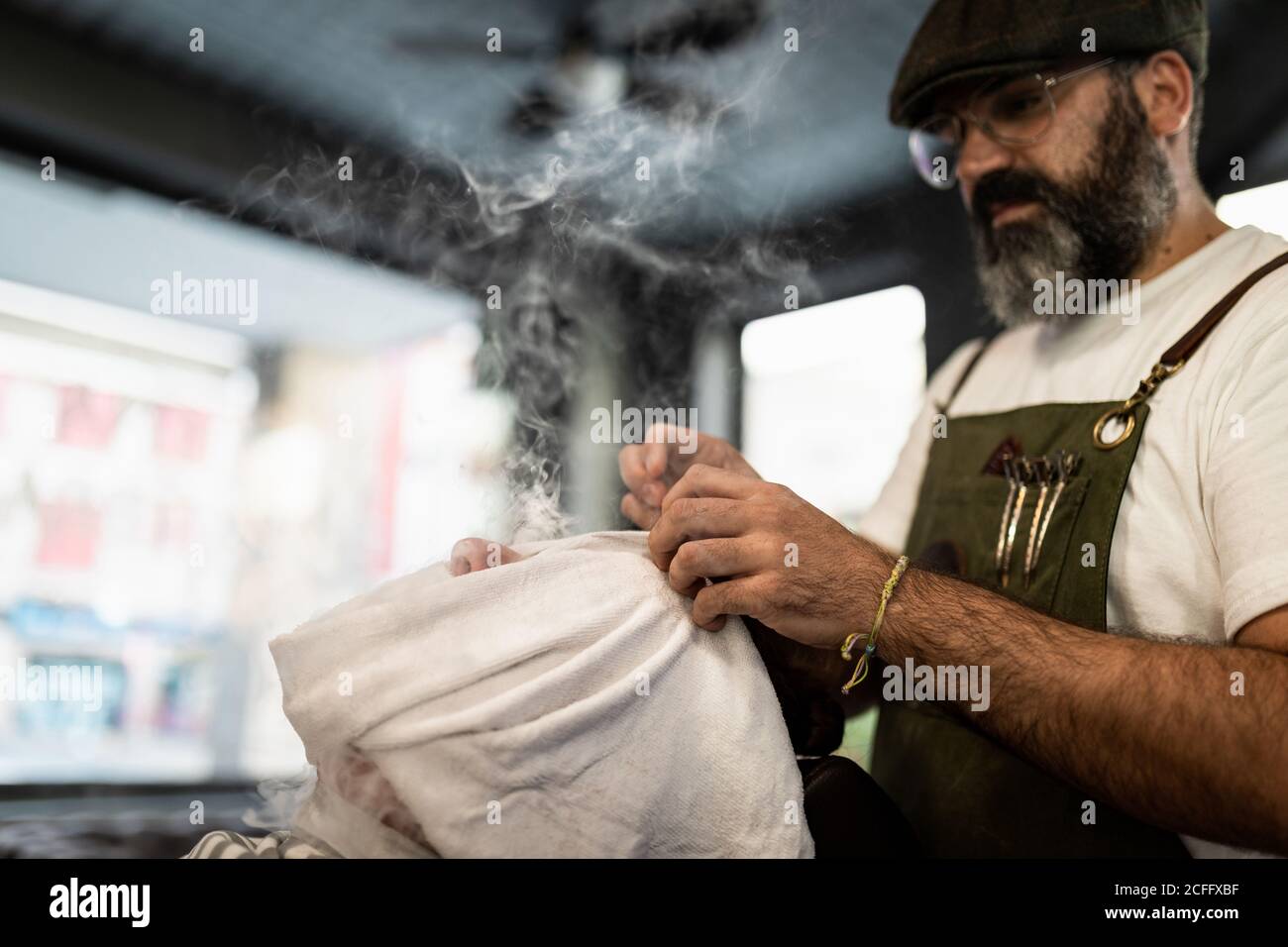 Barber doing facial massage hi-res stock photography and images