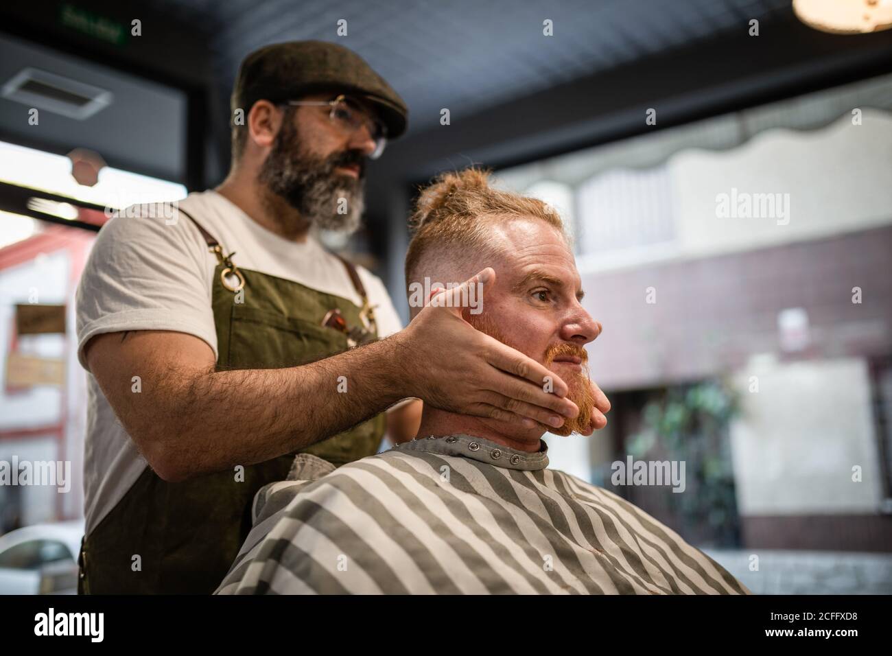 Barber doing facial massage hi-res stock photography and images