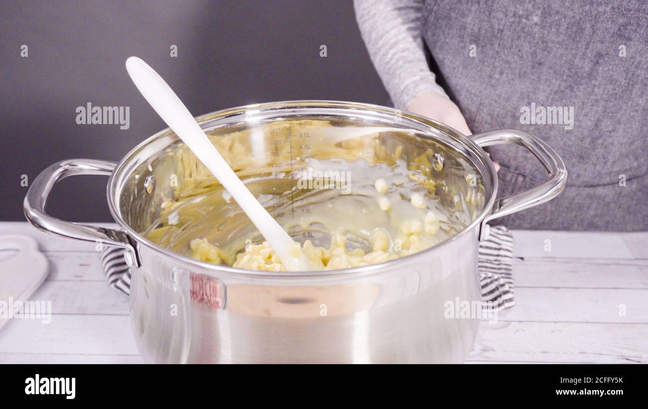Step by step. Melting white chocolate chips in the cooking pot to make