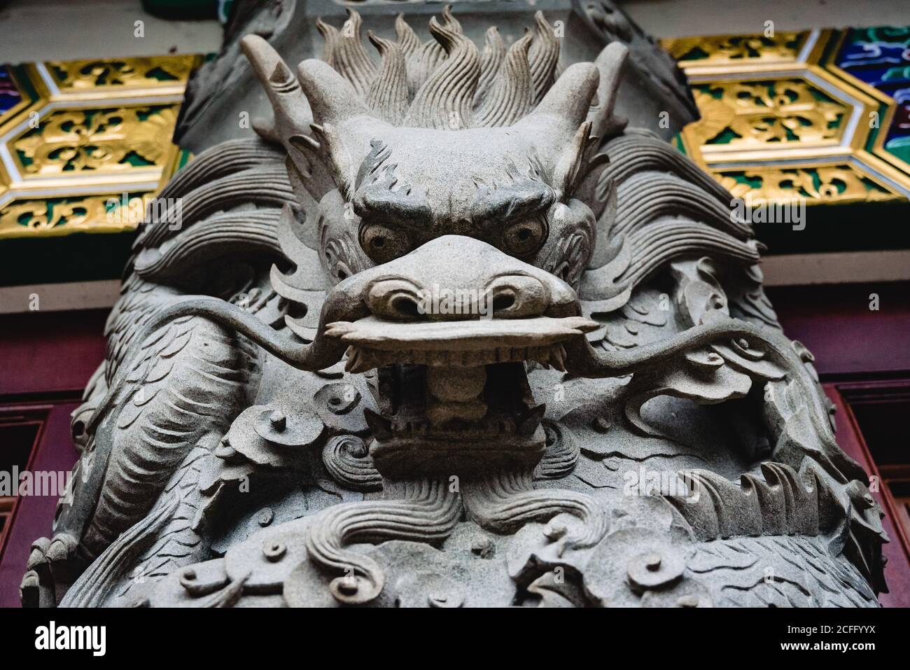 From below of ornamental carved stone dragon statue in traditional