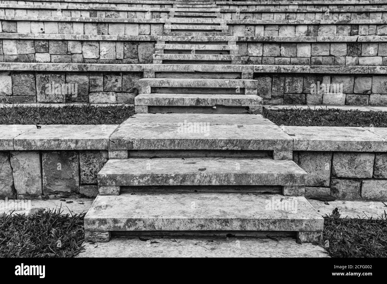 Black and white stone steps leading up among rows of tribunes in ancient temple in Mexico Stock Photo