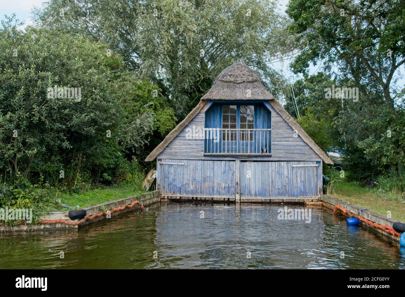 Frontal view of unique thatched roof boat house showing entrance facing
