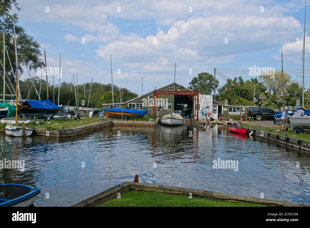 Boatyard on Broads water front. Boats afloat and on hard standing near
