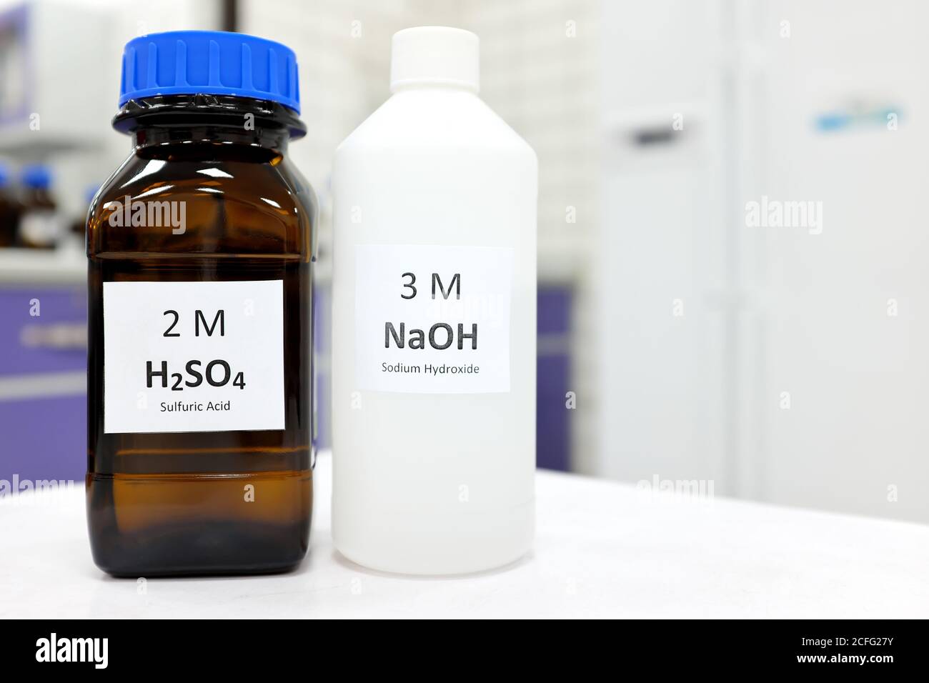 Selective focus of sodium hydroxide base and sulfuric acid solution in  brown glass and plastic bottle inside a chemistry laboratory. White  background Stock Photo - Alamy