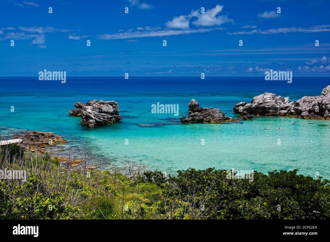 water scene, people snorkeling, varied blue shades, rock formations, vegetation, Tobacco Bay; St. George, Bermuda Stock Photo