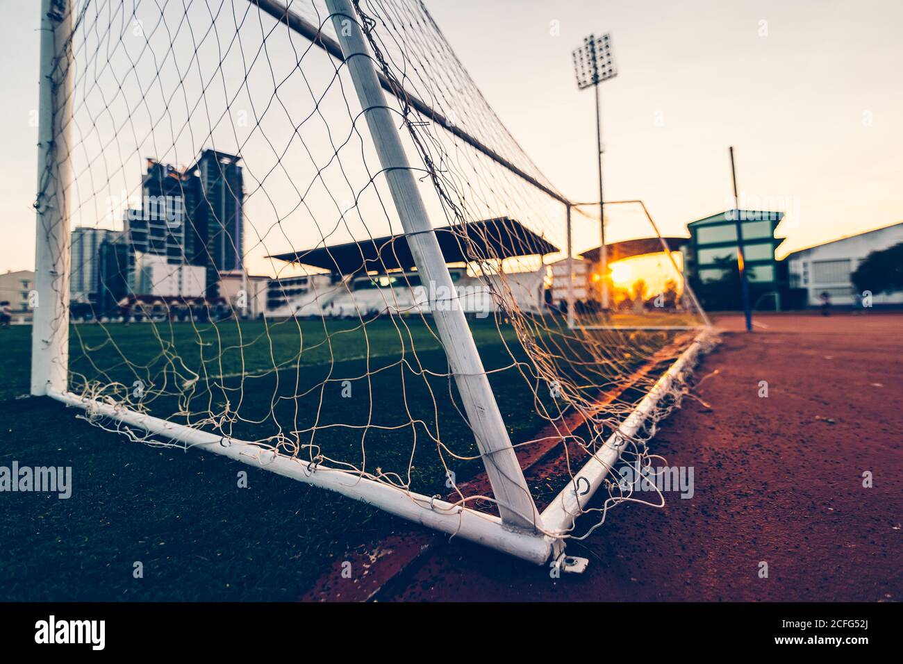 goal football at sport stadium and sunset. Stock Photo
