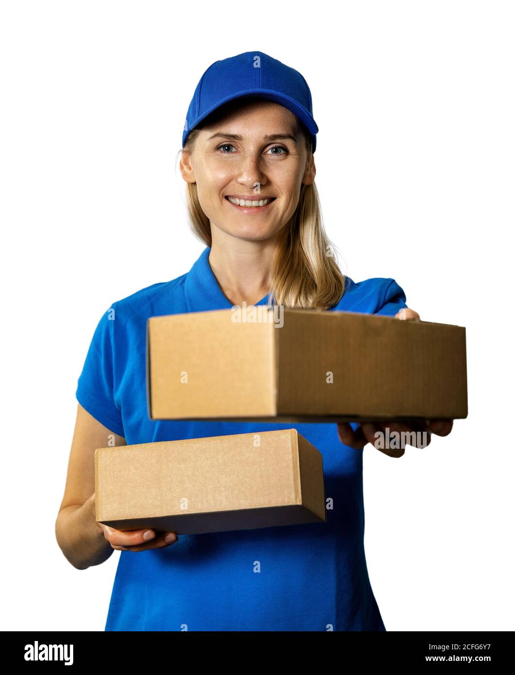 young smiling delivery woman giving cardboard package. isolated on white background Stock Photo