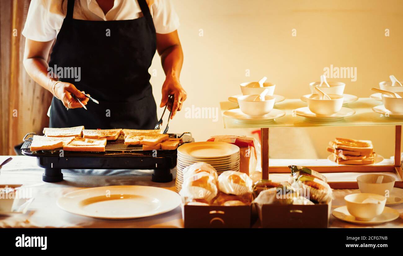 people use toaster for making breakfast in the hotel Stock Photo - Alamy