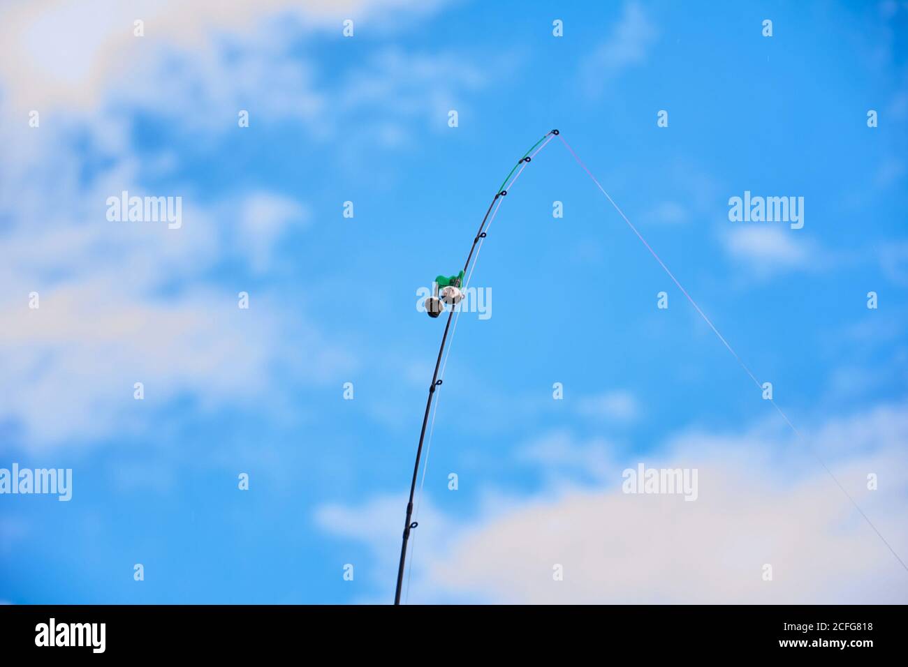 Fishing rod with bell on the feeder rod for signal. River view