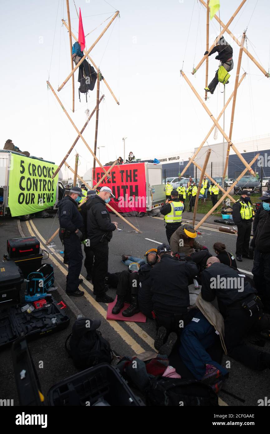Extinction Rebellion carried out Non Violent Direct Action to blockade News International's printworks to protest ownership of UK by oligarchs and their failure to 'Tell The Truth' adequately report the scale of the Climate Crisis and their frequent support for Climate scepticism or denialism. Times, Telegraph, Sun, Mail & Evening Standard were all mostly unable to distribute print editions. Credit: Gareth Morris/Alamy Live News Stock Photo