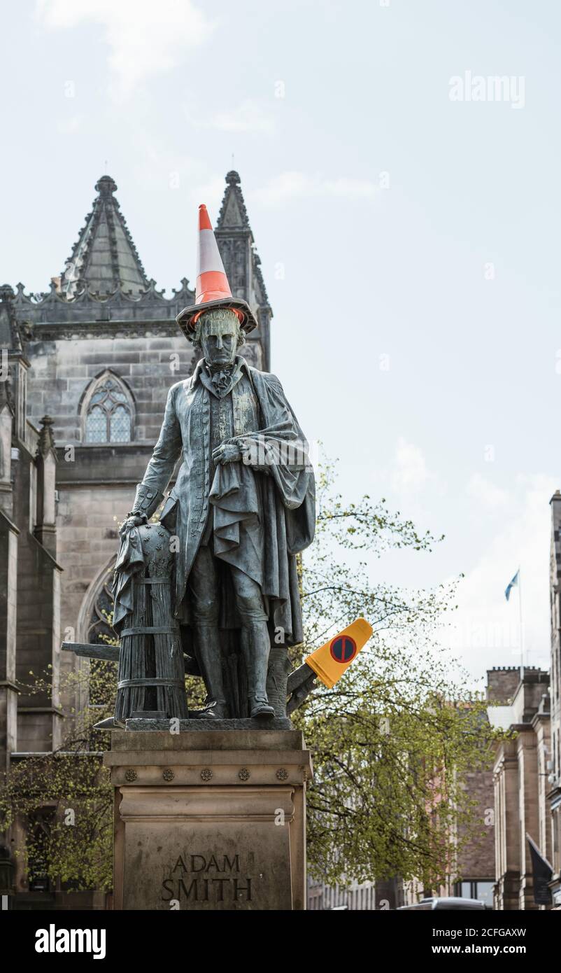From below sculpture man traffic road cone placed head hires stock